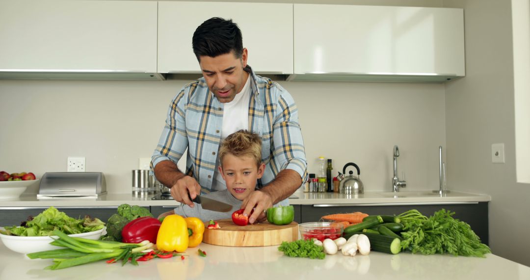 Father and Son Preparing Vegetables Together in Modern Kitchen - Free Images, Stock Photos and Pictures on Pikwizard.com