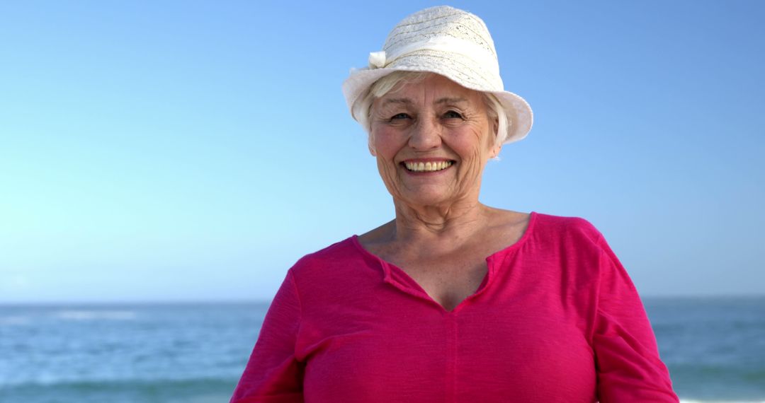 Happy Senior Woman Smiling at Beach in Summer - Free Images, Stock Photos and Pictures on Pikwizard.com