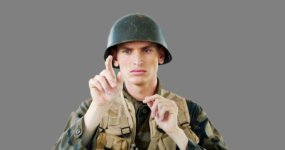 Determined Soldier Pointing Forward Isolated on Gray Background - Free Images, Stock Photos and Pictures on Pikwizard.com