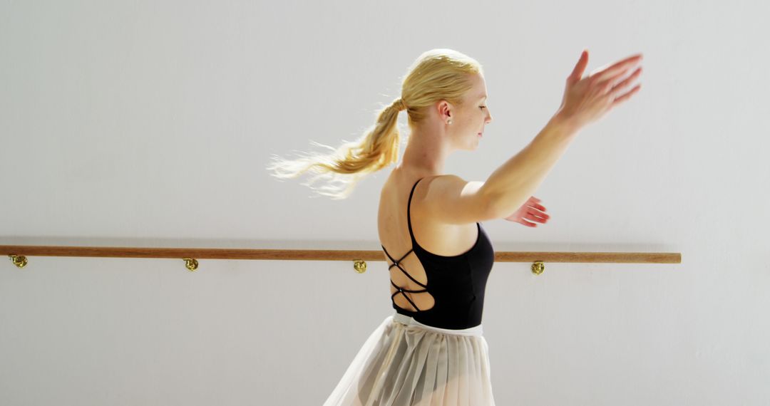 Graceful Ballerina in Elegant Studio Dance Pose with Copy Space