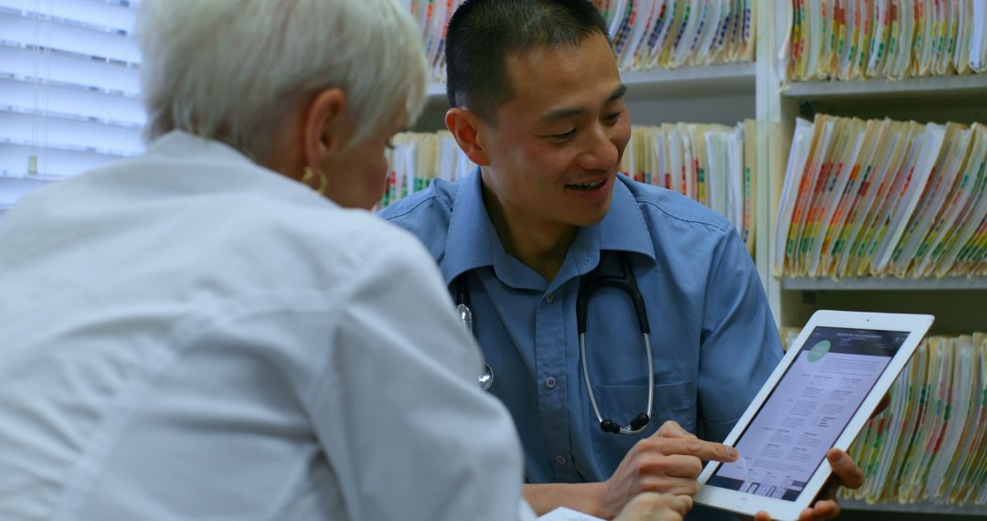 Doctor Consults Senior Patient with Digital Tablet in Office - Free Images, Stock Photos and Pictures on Pikwizard.com