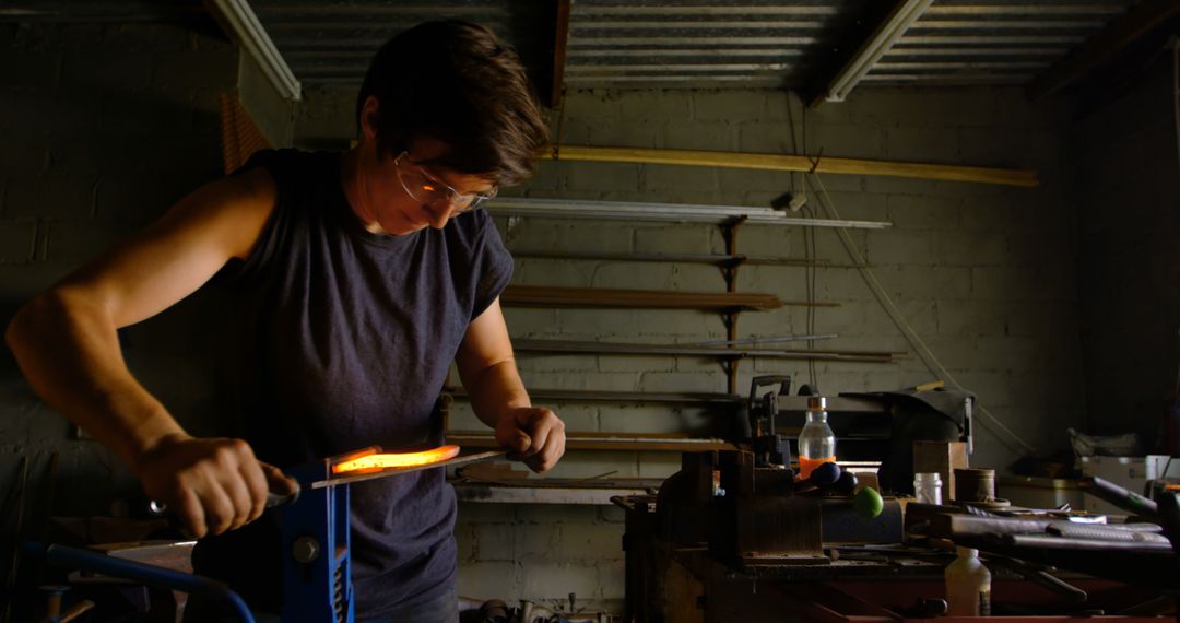 Blacksmith Shaping Glowing Hot Metal in Workshop - Free Images, Stock Photos and Pictures on Pikwizard.com