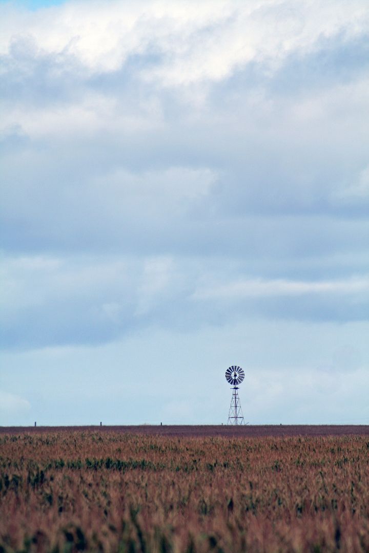 Solitary Windmill Amidst Open Plains Under Cloudy Sky - Free Images, Stock Photos and Pictures on Pikwizard.com