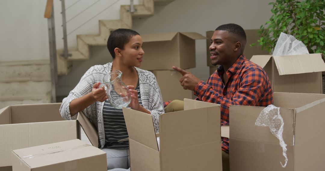 Couple Unpacking Moving Boxes in New Home