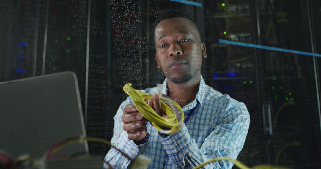 IT Specialist Analyzing Ethernet Cable in Data Center