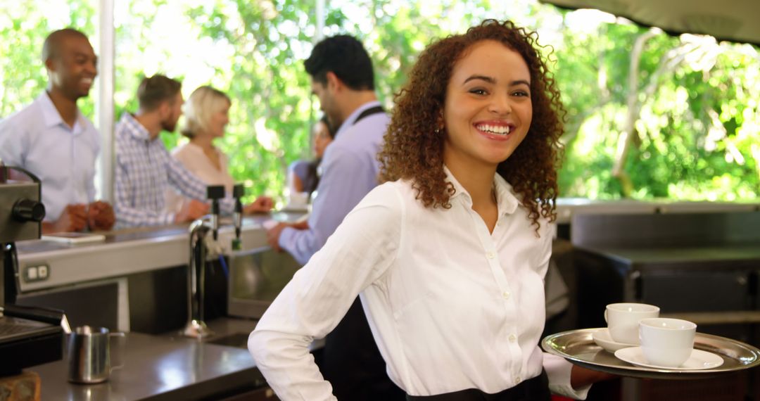 Smiling Waitress Serving Coffee at Outdoor Cafe - Free Images, Stock Photos and Pictures on Pikwizard.com