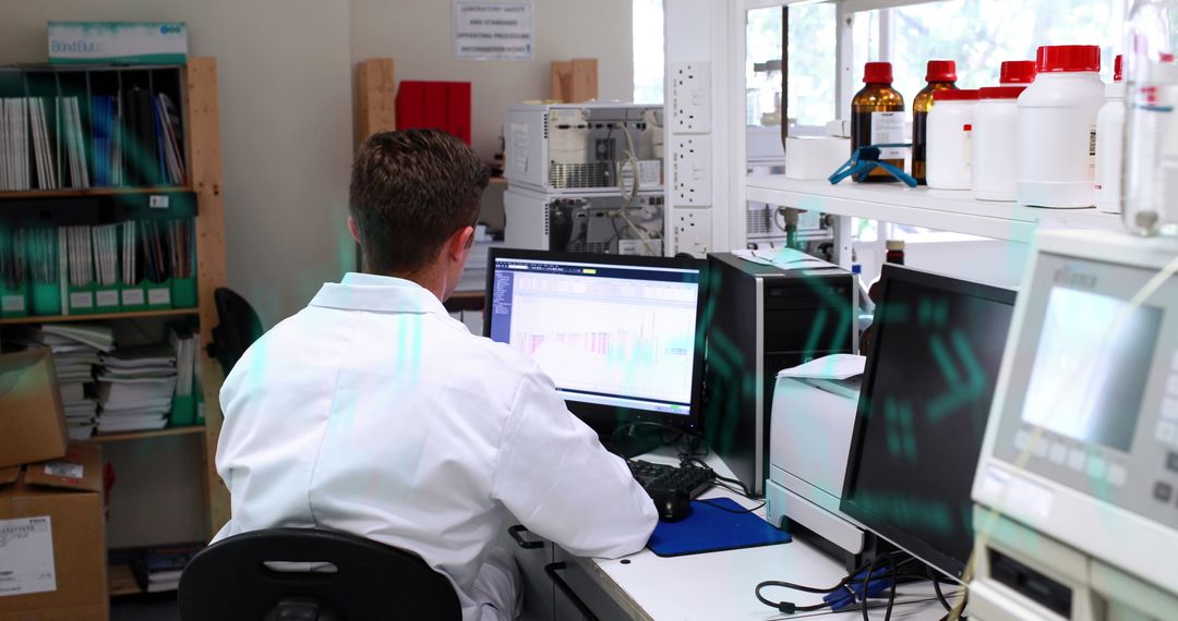 Lab technician analyzing data on computer in laboratory