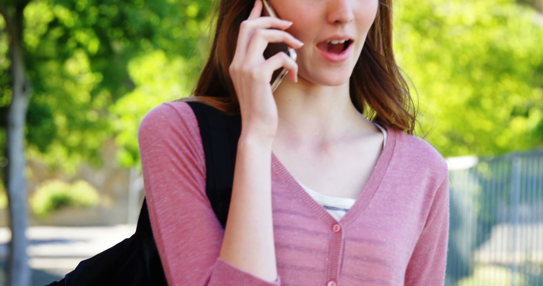 Young Woman Talking on Smartphone Outdoors - Free Images, Stock Photos and Pictures on Pikwizard.com