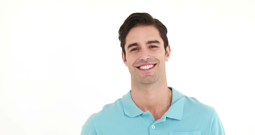 Confident Man Smiling in Light Blue Polo Shirt Against White Background - Free Images, Stock Photos and Pictures on Pikwizard.com