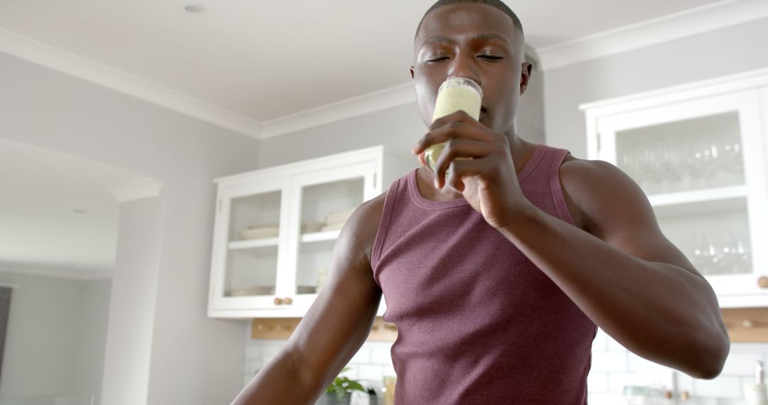 Young Man Drinking Healthy Smoothie in Home Kitchen - Free Images, Stock Photos and Pictures on Pikwizard.com