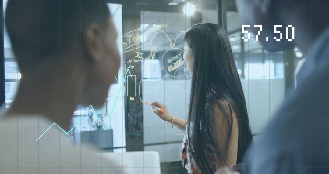 Teamwork Analyzing Financial Data in Modern Office Setting