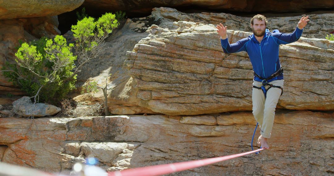 Man Balancing on Tightrope in Rocky Landscape - Free Images, Stock Photos and Pictures on Pikwizard.com