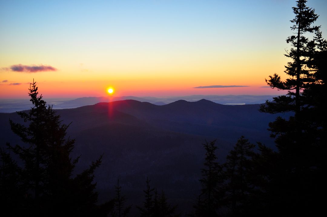 Sunrise Over Mountain Range with Silhouetted Trees - Free Images, Stock Photos and Pictures on Pikwizard.com