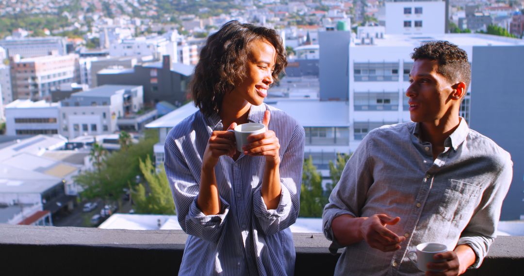 Young Couple Enjoying Coffee on Balcony Overlooking Cityscape - Free Images, Stock Photos and Pictures on Pikwizard.com