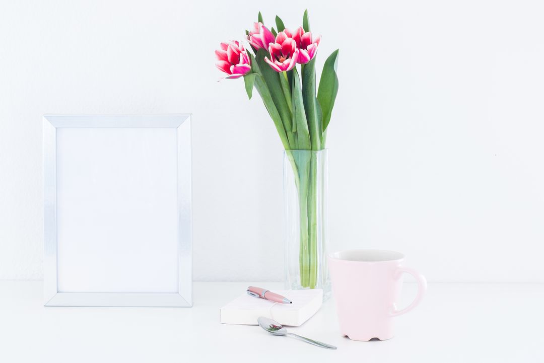 Elegant Workspace with Tulips and Pink Mug on White Desk