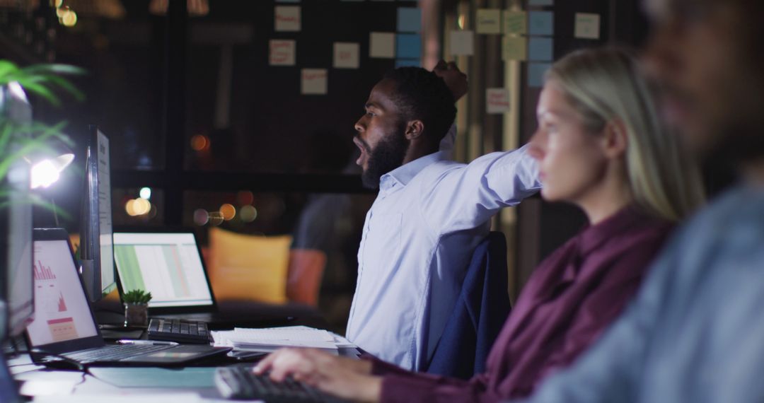 Tired Business Professionals Working Late in Modern Office