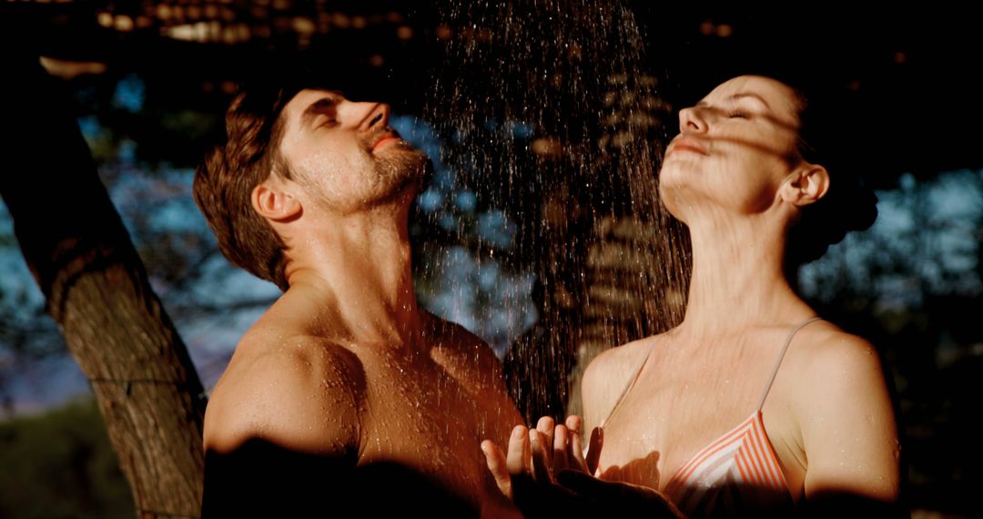 Romantic Couple Relaxing Under Outdoor Shower at Sunset - Free Images, Stock Photos and Pictures on Pikwizard.com