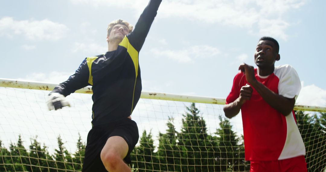 Goalkeeper Blocking Shot While Opponent Watches - Free Images, Stock Photos and Pictures on Pikwizard.com