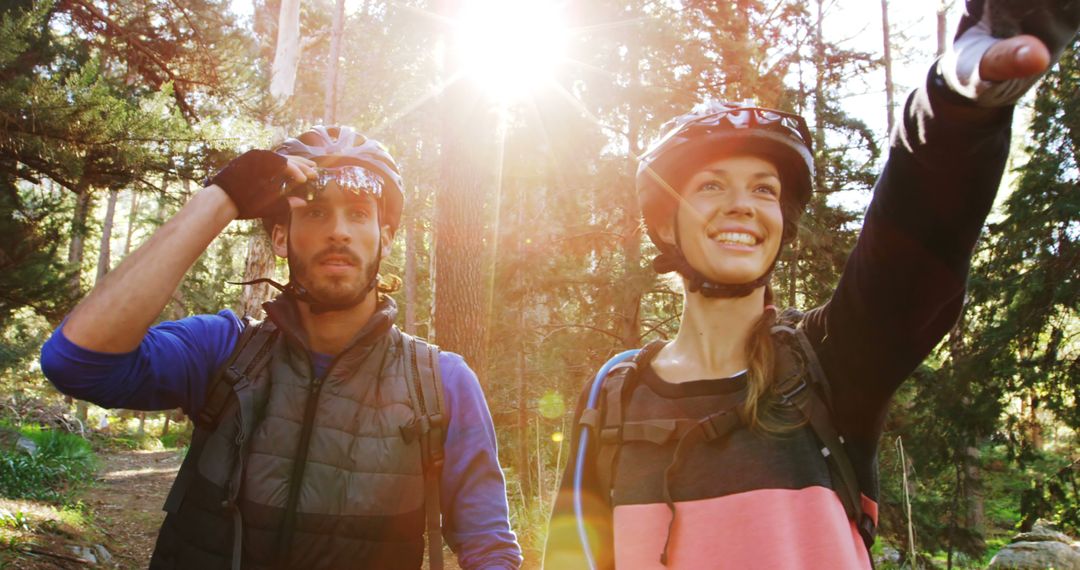 Couple Mountain Biking Together in Forest Under Sunlight - Free Images, Stock Photos and Pictures on Pikwizard.com