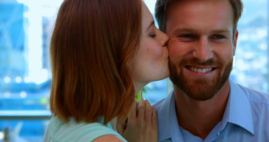 A young Caucasian couple shares a tender kiss, hinting at romance and celebration. - Free Images, Stock Photos and Pictures on Pikwizard.com