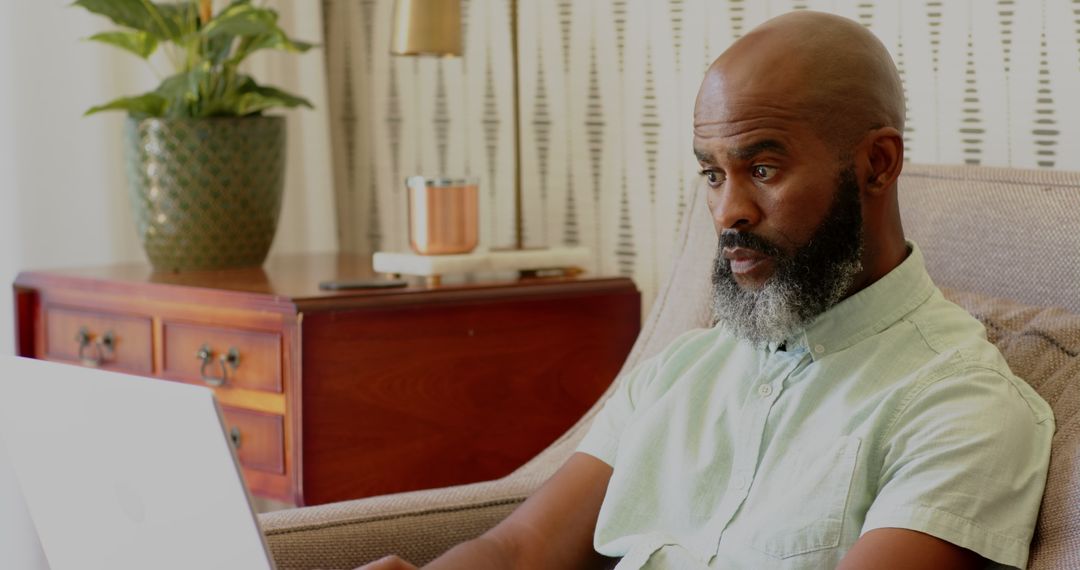 Man with Beard Working on Laptop at Home Office Environment