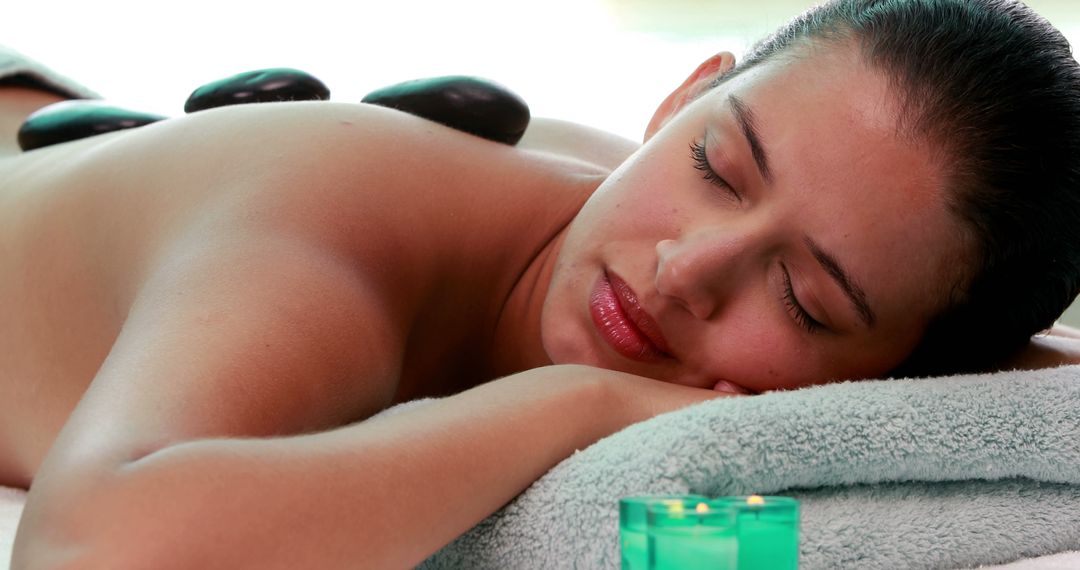 Woman Relaxing during Warm Stone Therapy in Spa - Free Images, Stock Photos and Pictures on Pikwizard.com