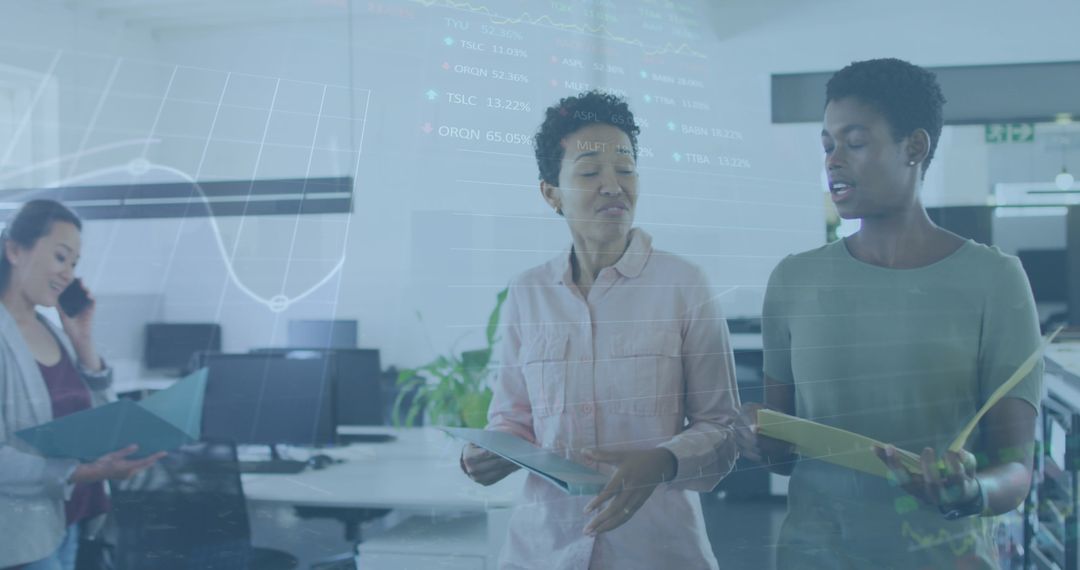 Women Analyzing Stock Market Data in Modern Office Setting