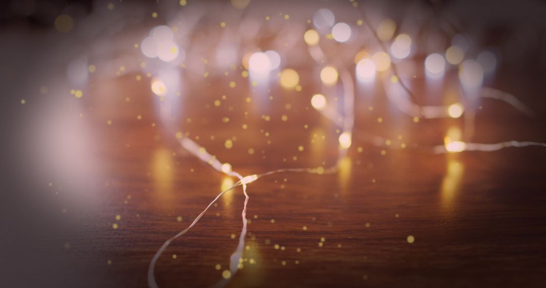 Twinkling Christmas Lights with Falling Snow on Wooden Surface