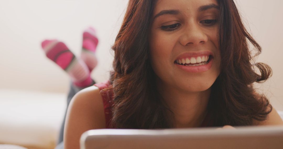Woman Relaxing at Home Smiling and Using Digital Tablet