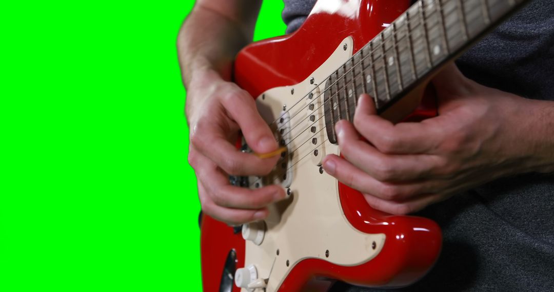 Mid section of male musician playing guitar against green screen - Free Images, Stock Photos and Pictures on Pikwizard.com