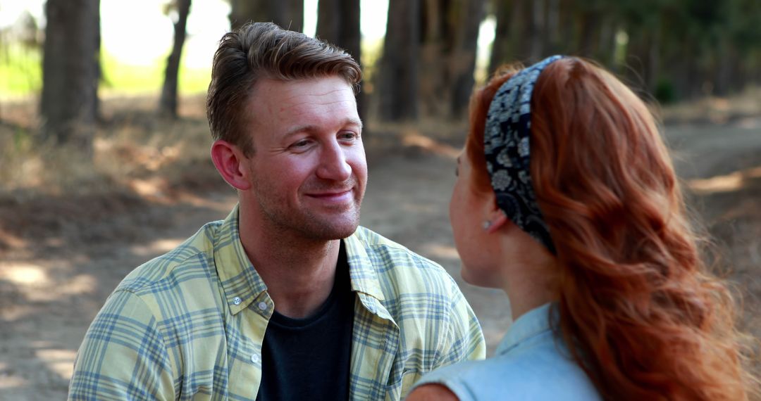 Couple Enjoying Conversation Outdoors by Tree Lined Path