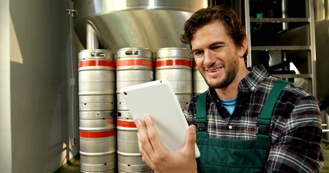 Smiling Male Brewer Checking Tablet In Brewery - Free Images, Stock Photos and Pictures on Pikwizard.com