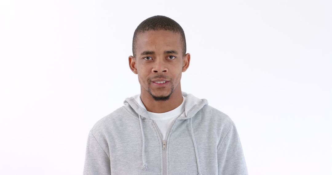 Young Man in Hoodie Displaying Anger with Intense Expression