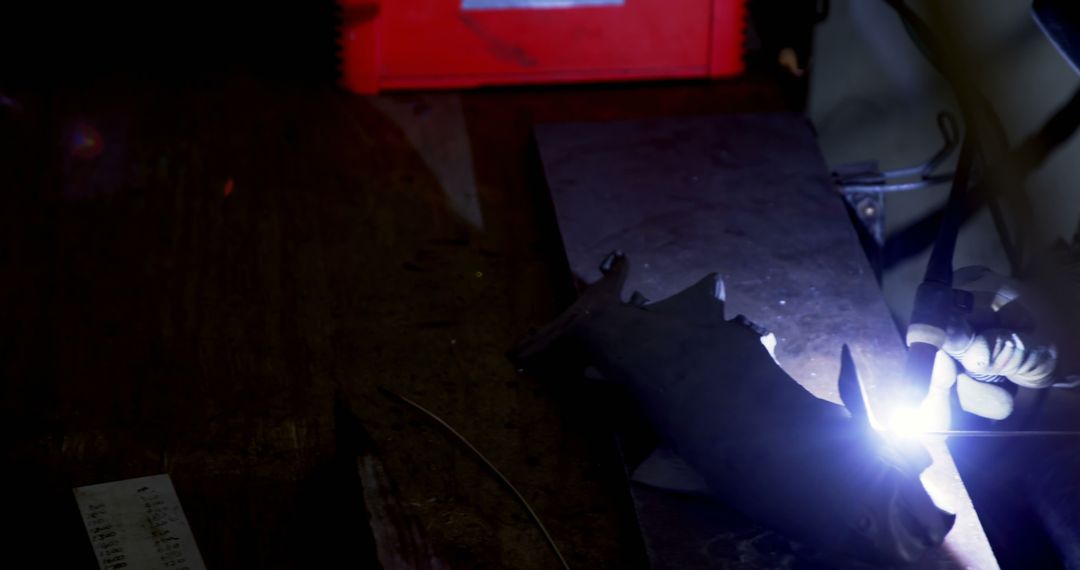 Worker Welding Metal in Dark Workshop - Free Images, Stock Photos and Pictures on Pikwizard.com