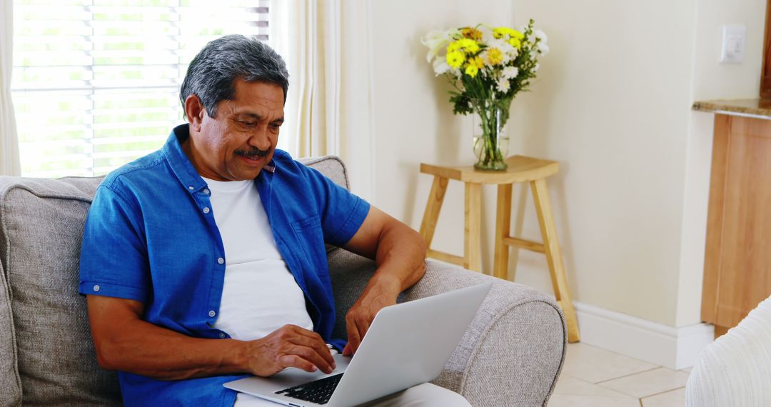 Senior Man Using Laptop on Couch, Relaxing at Home - Free Images, Stock Photos and Pictures on Pikwizard.com