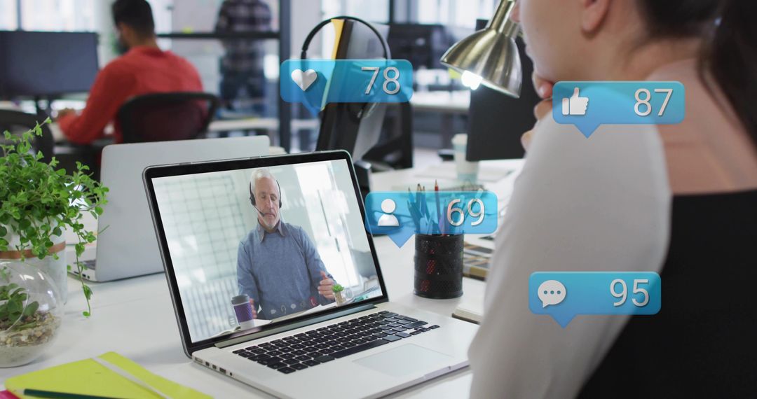 Woman attending virtual meeting at modern office desk with social media overlay icons and headset
