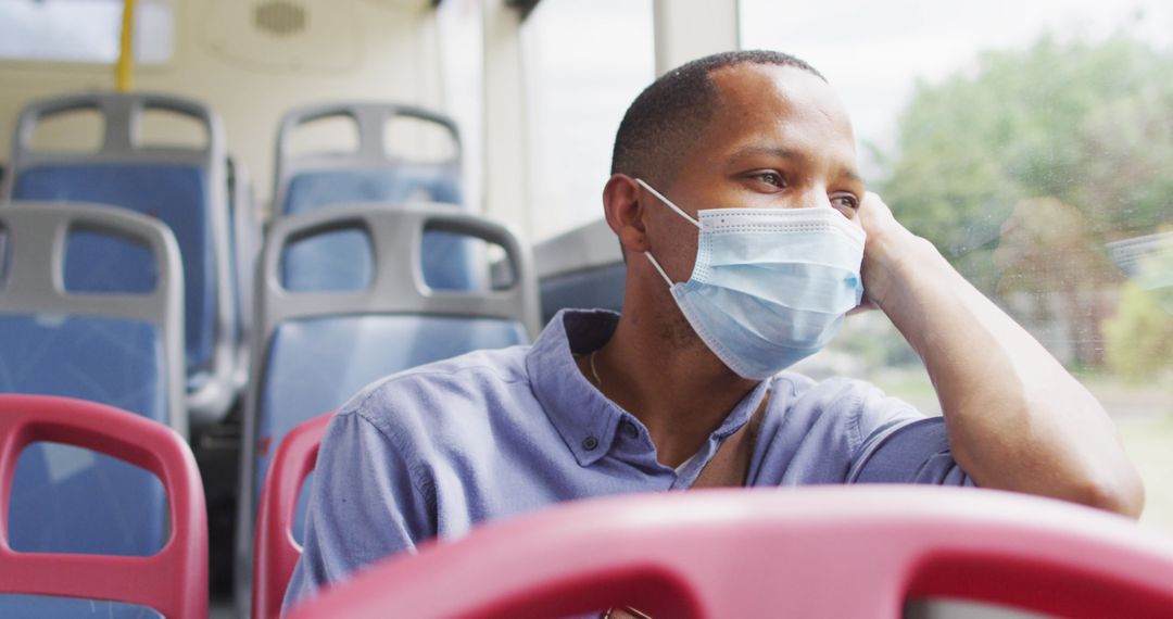 Pensive Man in Face Mask on City Bus During COVID-19