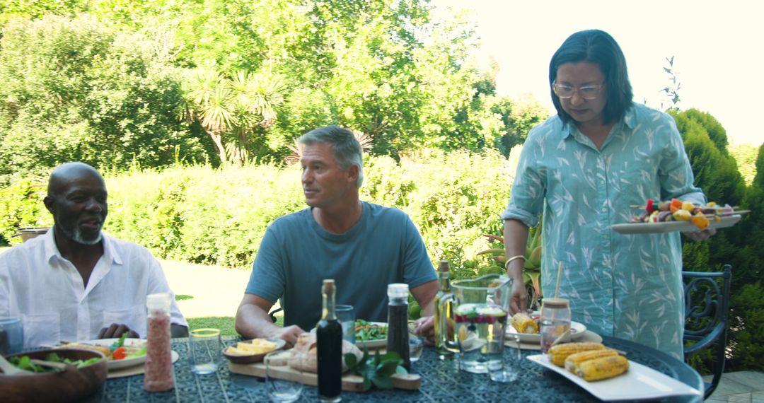 Diverse Group Enjoying Al Fresco Dining Experience on Sunny Day