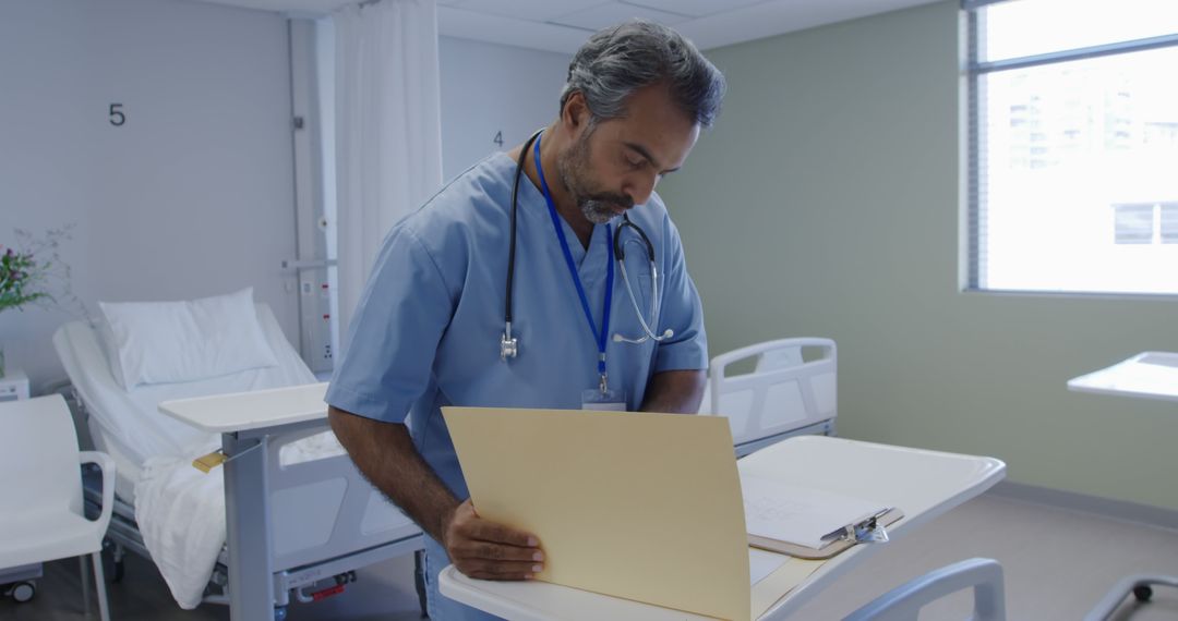 Doctor reviewing patient files in hospital ward - Free Images, Stock Photos and Pictures on Pikwizard.com