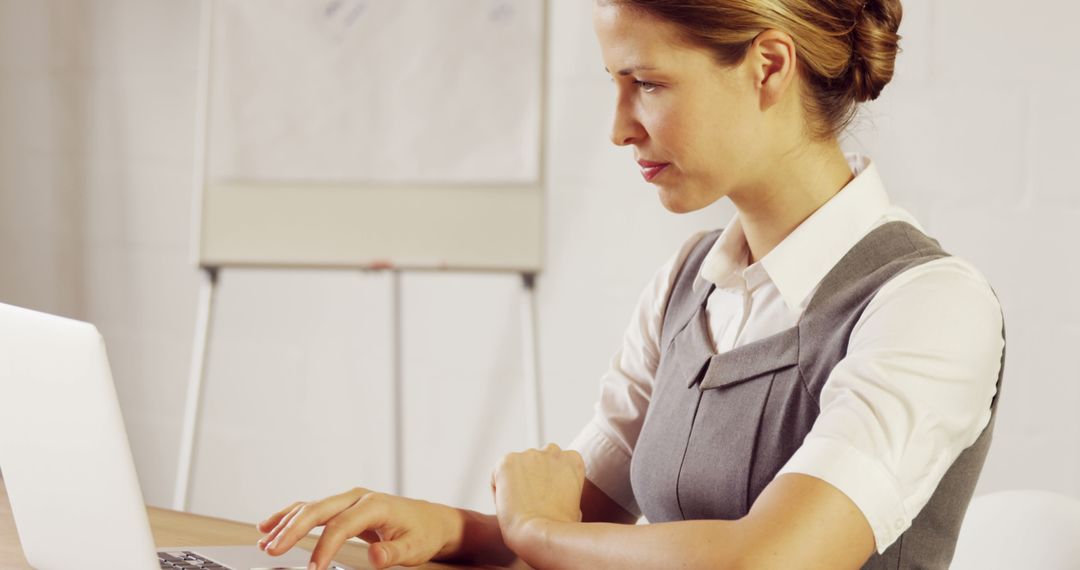 Professional Woman Working on Laptop in Office Setting - Free Images, Stock Photos and Pictures on Pikwizard.com