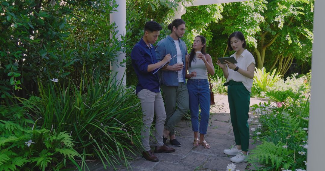 Group of Young Adults Exploring Lush Garden Environment