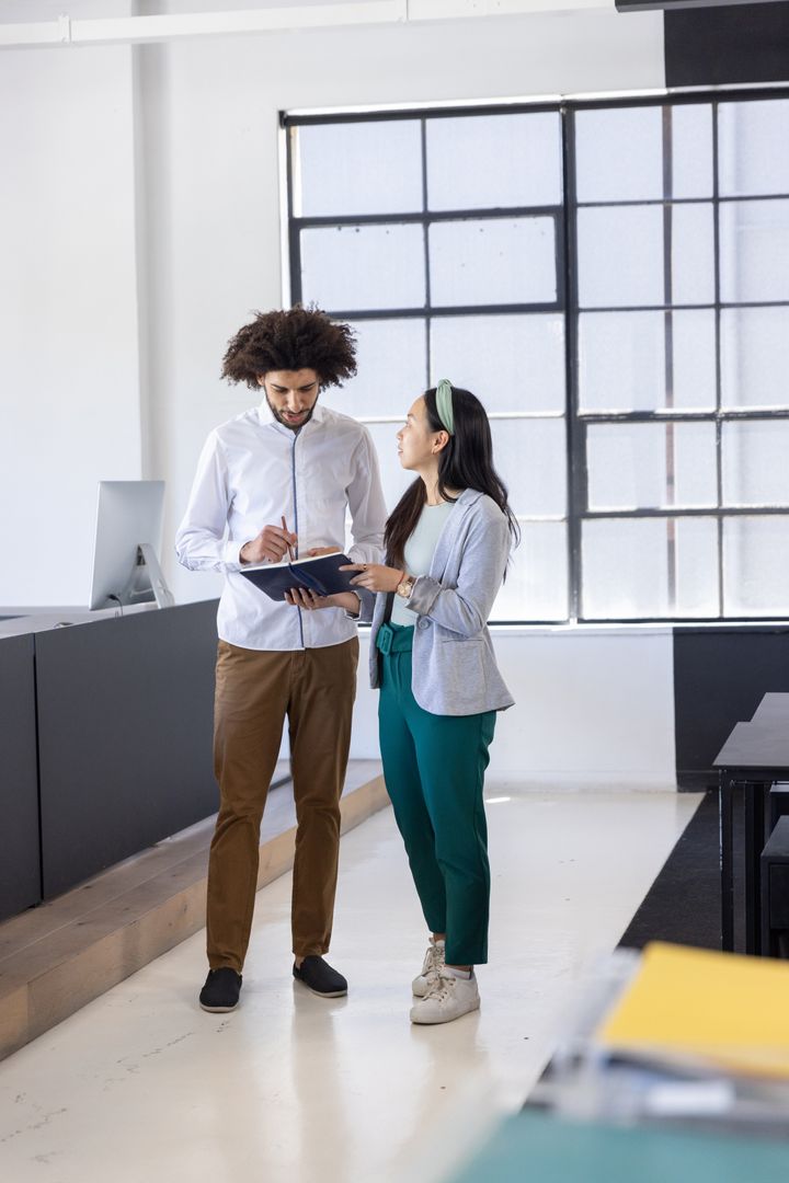 Diverse Coworkers Collaborating in Sunny Modern Office