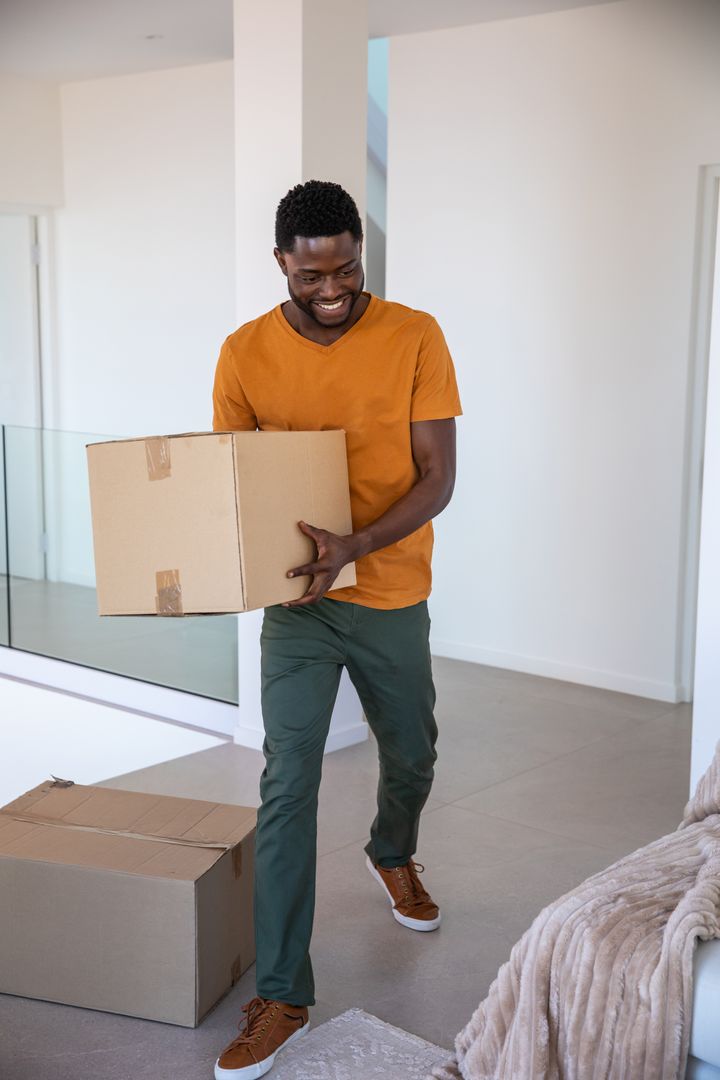 Man Moving Boxes in Contemporary Minimalistic Home Interior