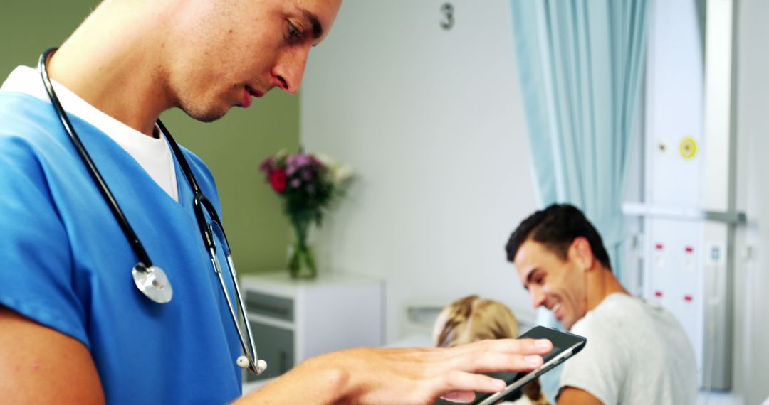 Male Nurse Checking Tablet While Family is Talking - Free Images, Stock Photos and Pictures on Pikwizard.com