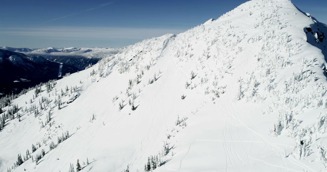 Aerial View of Snow-Covered Mountain Peak in Winter - Free Images, Stock Photos and Pictures on Pikwizard.com