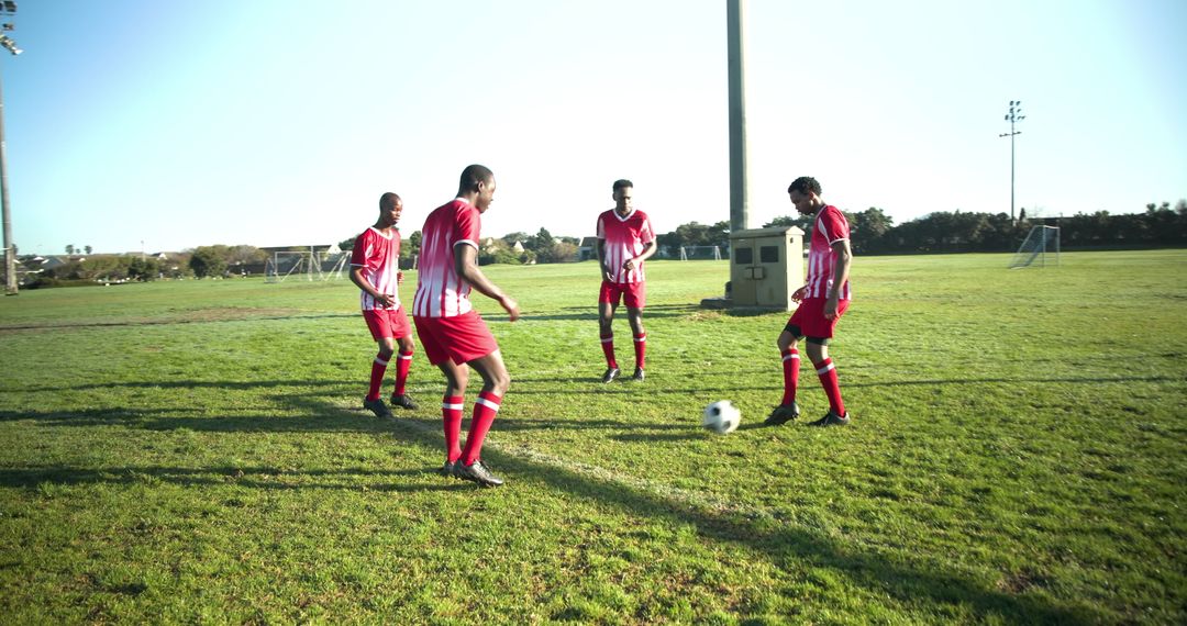 Soccer Players Practicing on Field in Team Uniforms