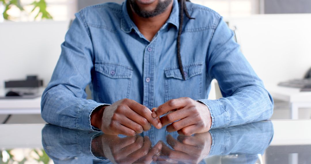 Man in Denim Shirt in Office Meeting Setting Collaborative Idea Exchange