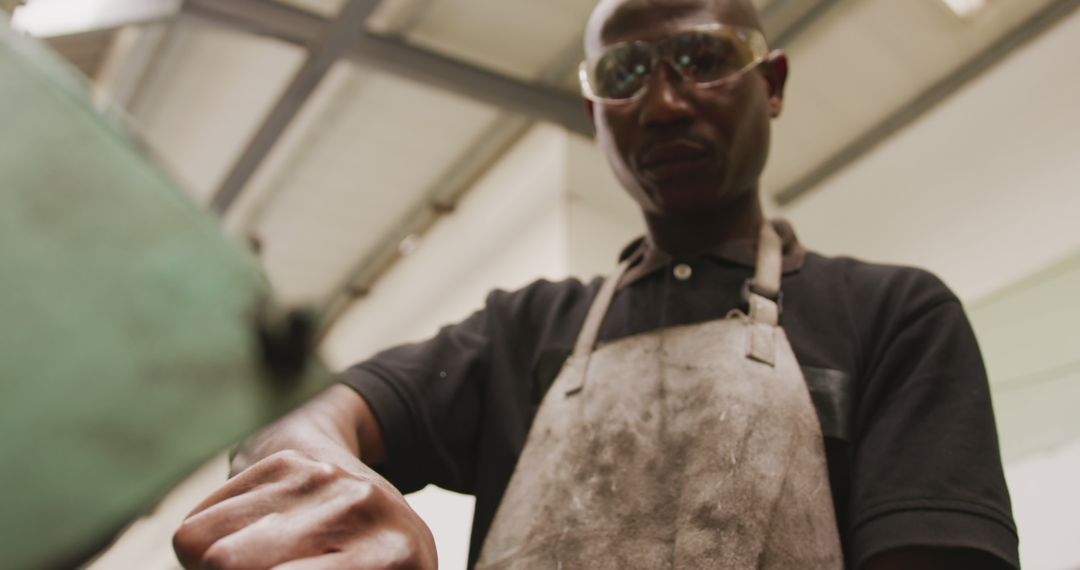 Focused African American Man Working in Industrial Workshop - Free Images, Stock Photos and Pictures on Pikwizard.com