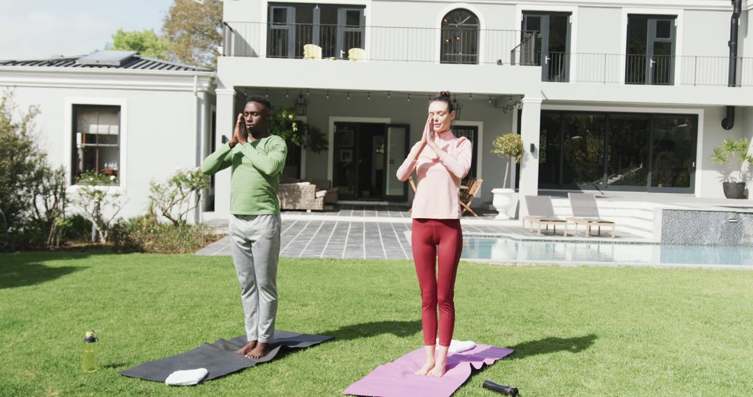 Couple Practicing Yoga in Backyard of Modern Home - Free Images, Stock Photos and Pictures on Pikwizard.com