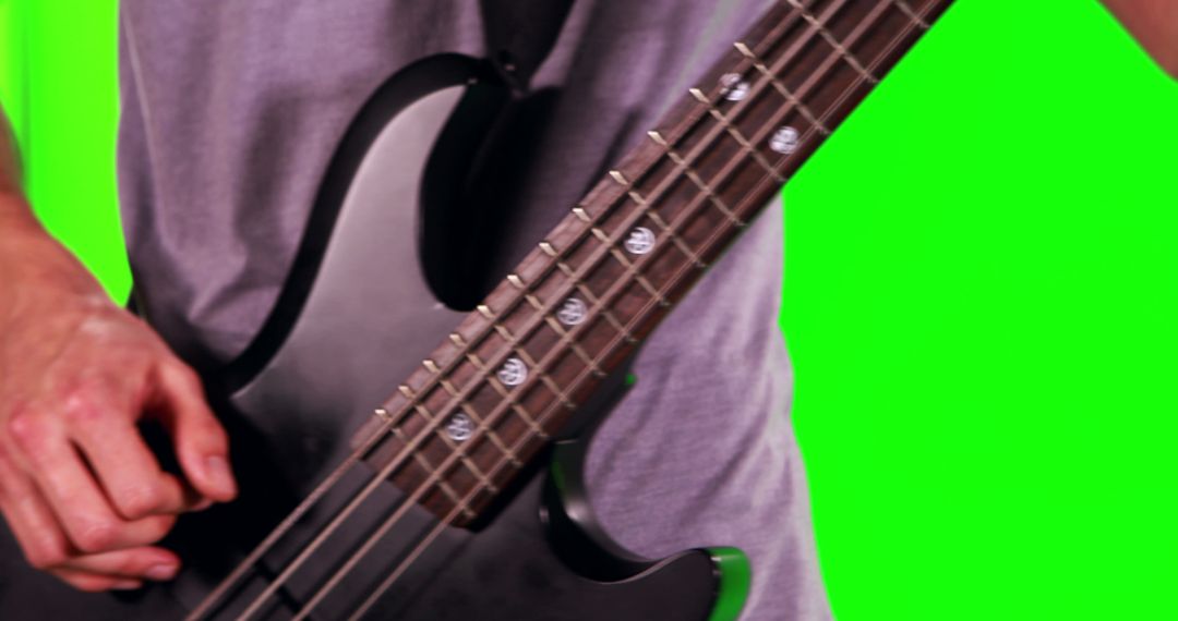 Person Playing Bass Guitar with Vibrant Green Background - Free Images, Stock Photos and Pictures on Pikwizard.com